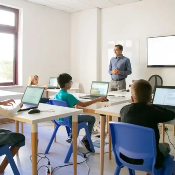 Teacher And Student Learn In Classroom Using Smartboard