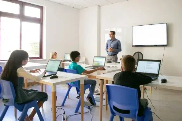 Teacher With Student Using Smartboard